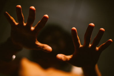 Close-up of silhouette hands against blurred background