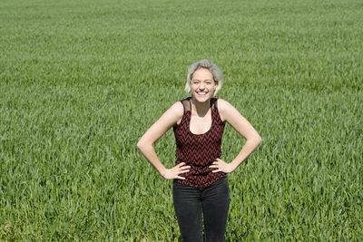 Portrait of a smiling young woman on field