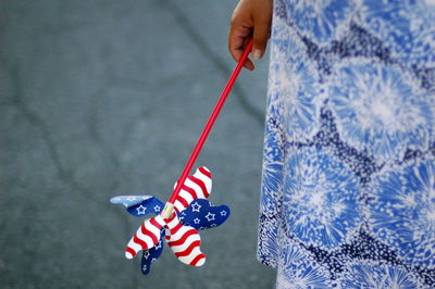 Midsection of woman holding american flag pinwheel