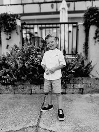 Portrait of boy standing against sea beach