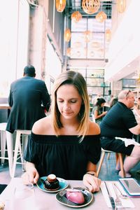 Young woman sitting on table