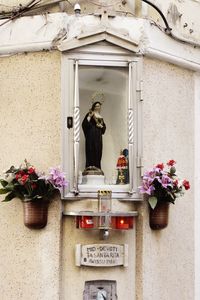 Statue against flowers