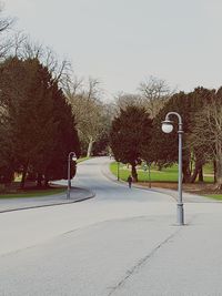 Road amidst trees against sky