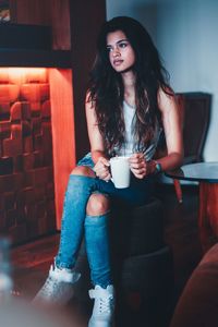 Young woman drinking coffee in cafe