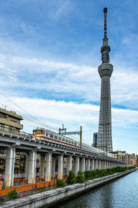 Metro train under tokyo skytree, the tallest tv tower in the world, japan