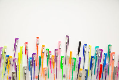 Close-up of colored pencils over white background