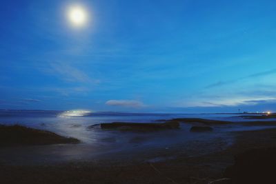 Scenic view of beach against sky at night