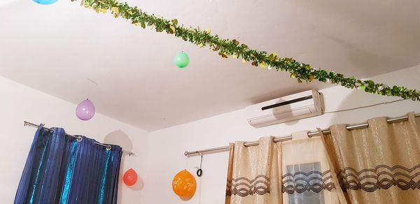 Low angle view of multi colored balloons hanging on ceiling