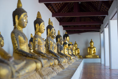 Buddha statue in temple against building