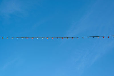 Low angle view of vapor trail against clear blue sky