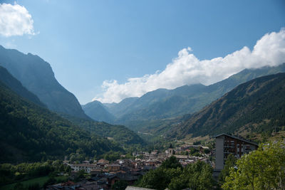 Scenic view of mountains and houses against sky