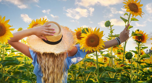 Low angle view of woman standing amidst plants