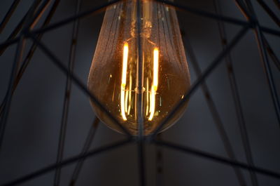 Close-up of illuminated light bulb on ceiling