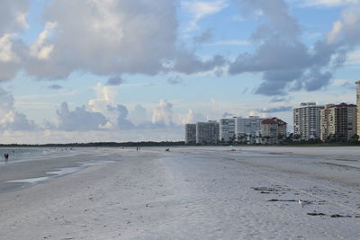 Panoramic view of beach and buildings against sky