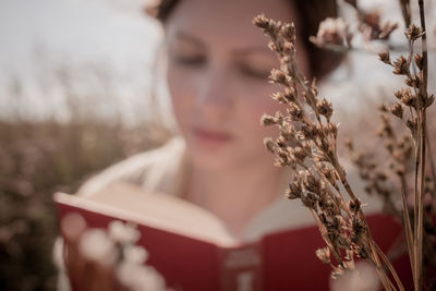 Close-up portrait of a girl holding book 