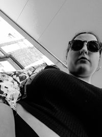 Low angle view of young man wearing sunglasses