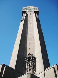 Low angle view of tower against clear blue sky during sunny day