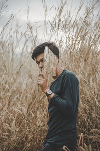 Man wearing hat standing on field