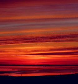 Scenic view of silhouette landscape against orange sky