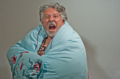 Portrait of mid adult man standing against wall