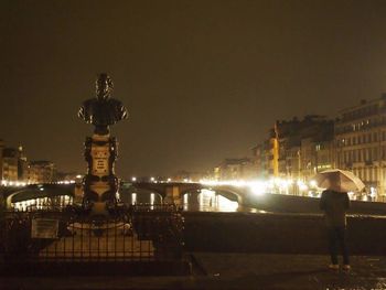 Statue of illuminated city at night