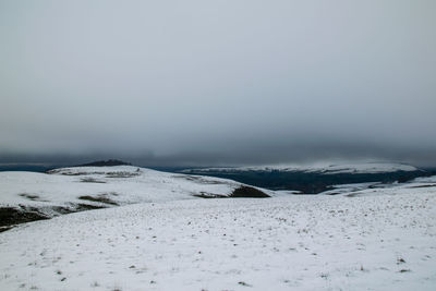 Scenic view of snow covered land against clear sky