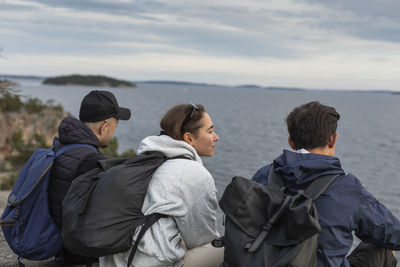 Friends sitting together at sea