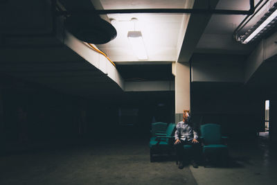 Man wearing mask sitting on seat