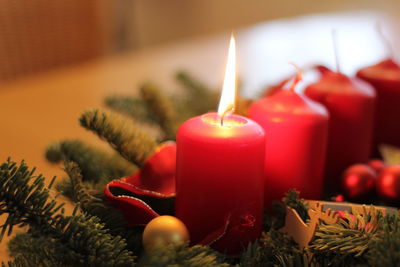 Close-up of lit candles on table