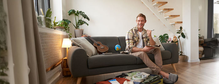 Portrait of woman sitting on sofa at home