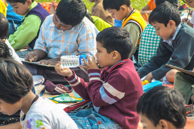 Rear view of people sitting outdoors