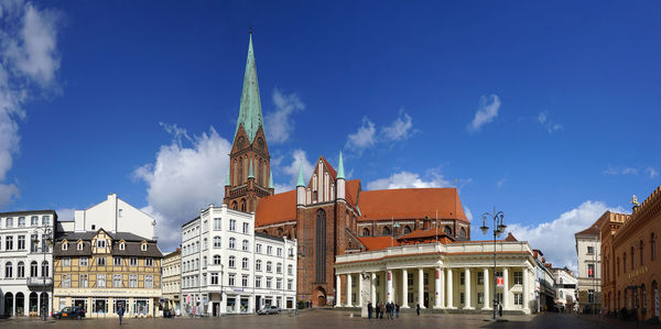 Panoramic view of market square against blue sky