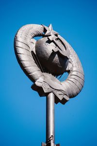 Low angle view of sculpture against blue sky