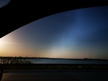 Scenic view of silhouette car against sky during sunset