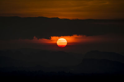 Scenic view of silhouette mountain against romantic sky at sunset