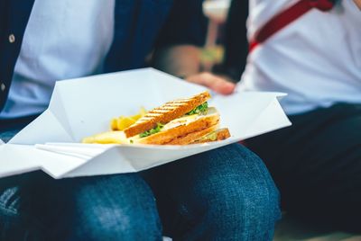 Close-up of person eating sandwich