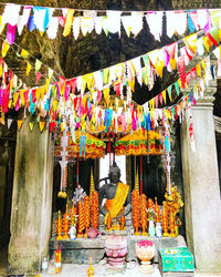 Multi colored statues hanging outside building