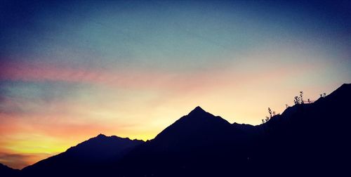 Low angle view of silhouette mountain against sky
