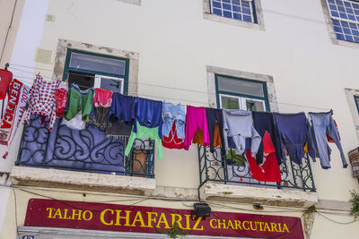 Low angle view of clothes drying outside building