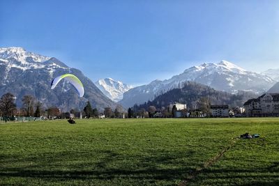 Scenic view of grassy field against cloudy sky