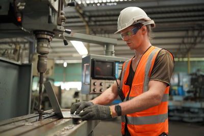 Rear view of man working in workshop