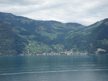 Scenic view of mountain range against cloudy sky