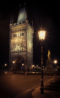 Statue of illuminated city at night