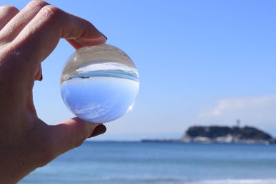 Close-up sea reflecting on circular ball