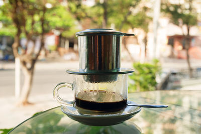 Drip black coffee in vietnamese style with condensed milk on a glass. method of making coffee.