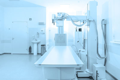 X-ray department in modern hospital. radiology room with scan machine with empty bed. 