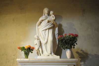 Statue of buddha against wall