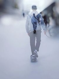 Double exposure of man skateboarding on snow