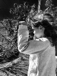 Side view of boy looking at tree