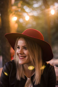 Portrait of a smiling young woman wearing hat